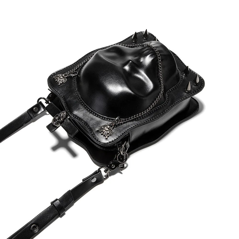 Black gothic crossbody bag with embossed skull design, chain strap and square shape