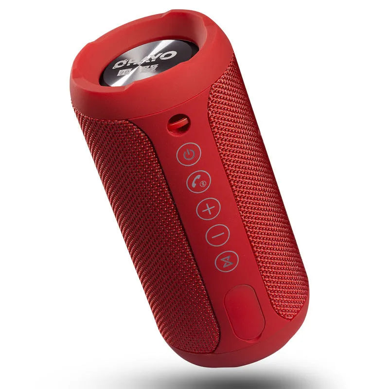 Black outdoor waterproof portable Bluetooth speaker on a grassy surface