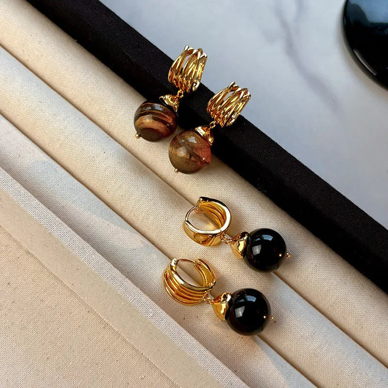 Geometric round tigereye stone earrings for women with gold plating in black and brown.