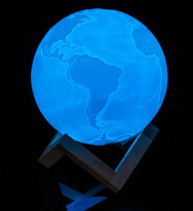 3D printed moon lamp on wooden stand with touch control ring at base, showing white and yellow light colours.