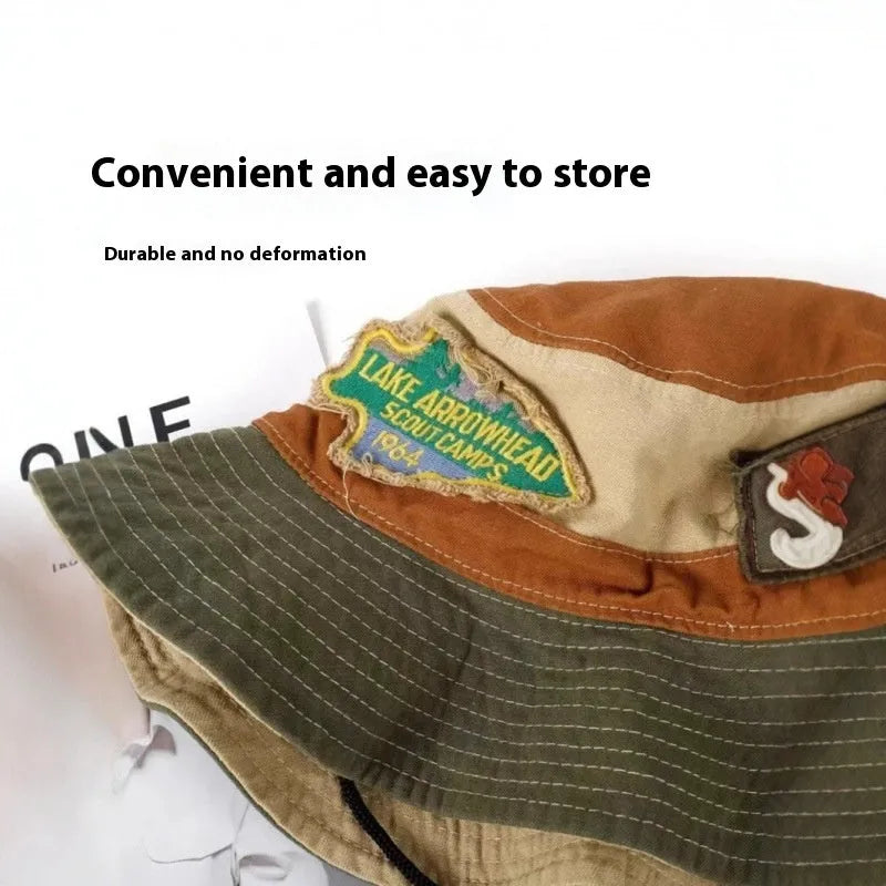 Army green foldable cotton fisherman hat with hand-painted patchwork design and flat top crown.