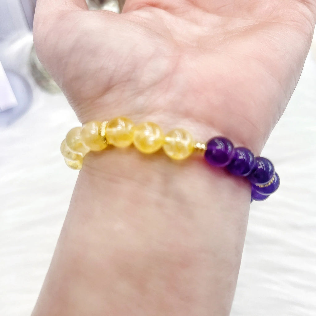 Handmade women's bracelet with yellow and purple crystal amethyst stones on adjustable clasp