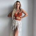 Women's white backless push-up bikini three-piece set with matching skirt on a mannequin.