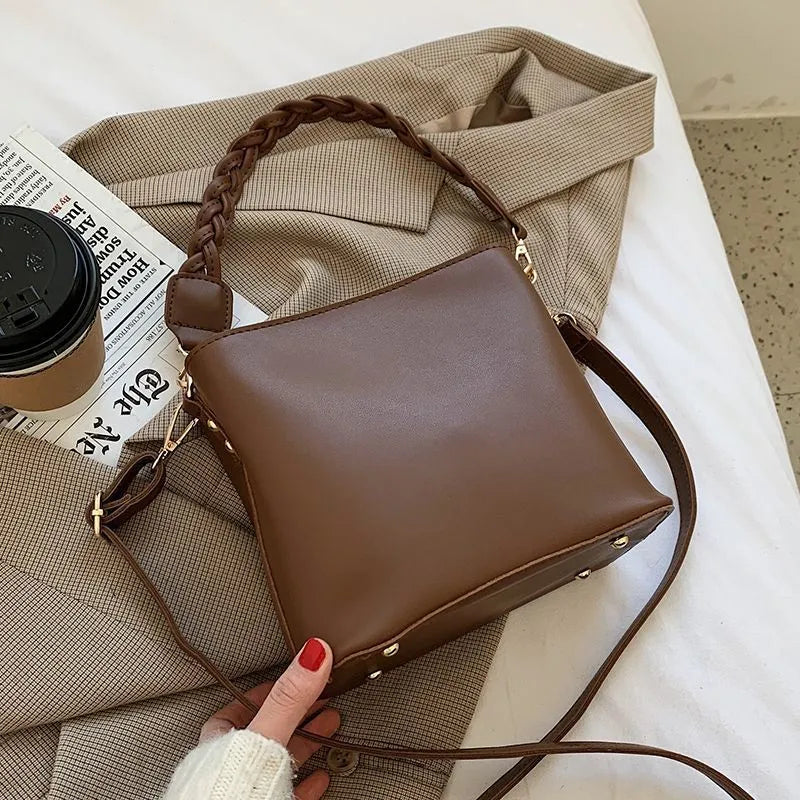 Retro brown bucket bag with weaving pattern, showing crossbody strap and underarm design