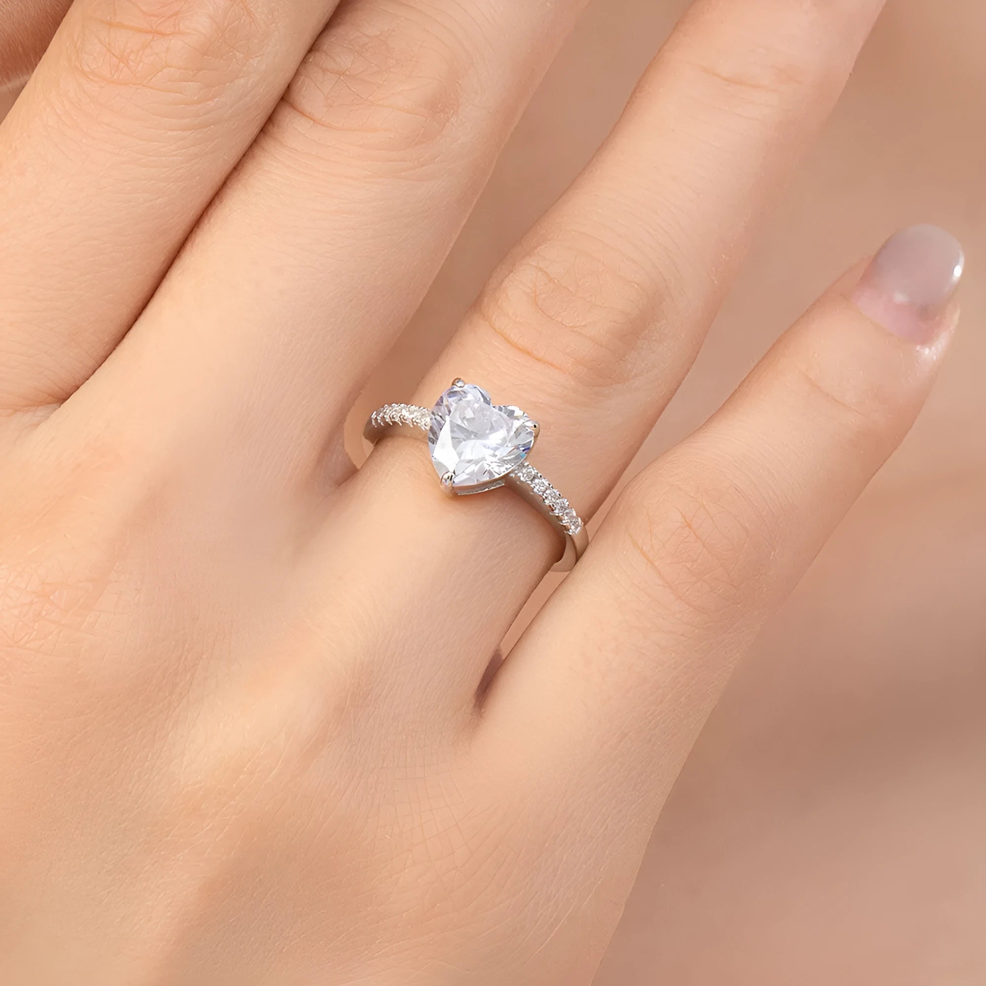 Women's sterling silver love ring with heart-shaped zircon stone in white color on display