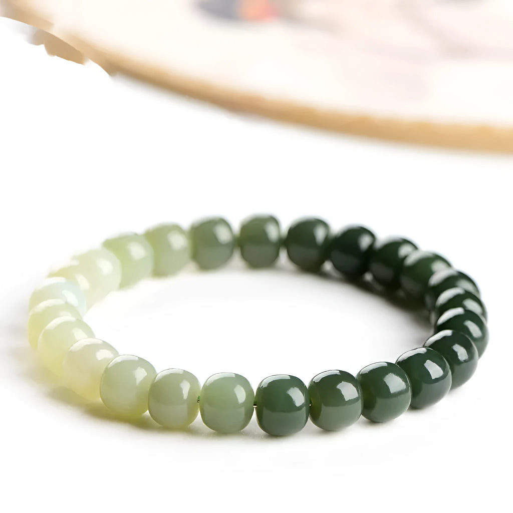 Natural Hetian jade bracelet showing a sunny water gradient colour on polished beads.