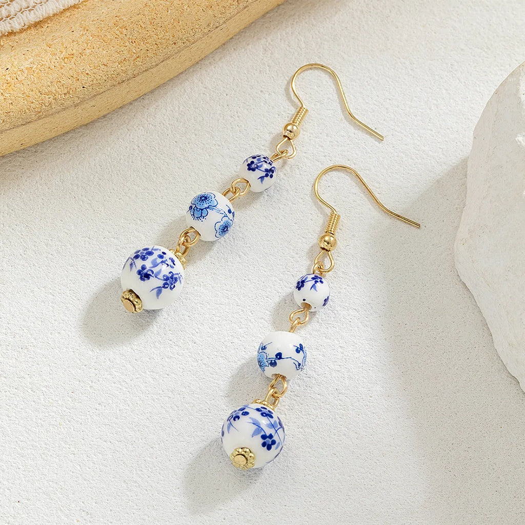 Blue and white porcelain ceramic bead retro earrings with geometric alloy components