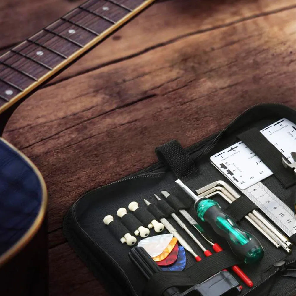Black plastic and metal guitar repair tool kit for guitars, basses, mandolins, and banjos.