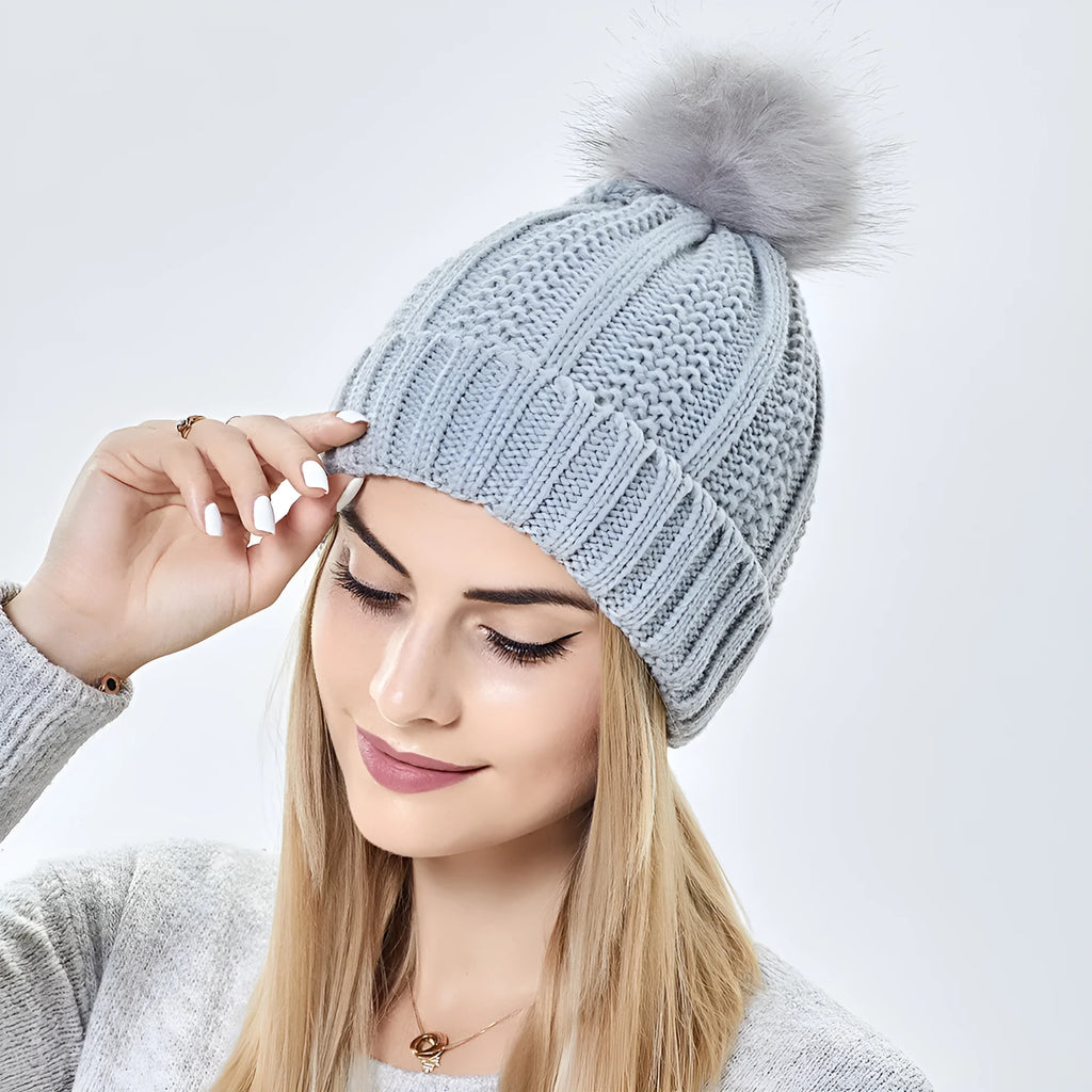 Women's knitted beanie hat with satin lining in various colours on a mannequin head.
