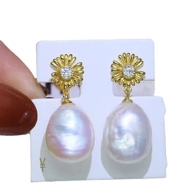 Baroque-style S925 sterling silver floral jewellery holder with pair of earrings on silver frame.