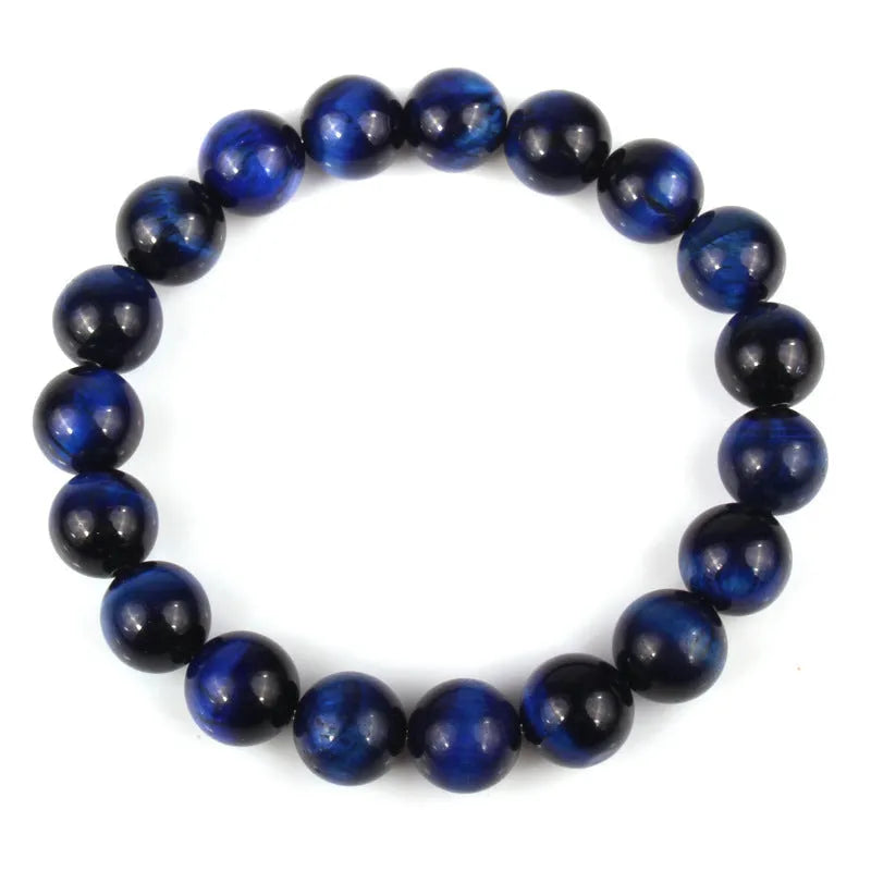 Natural tiger eye crystal bracelet with round beads in multiple colour options on a wrist.