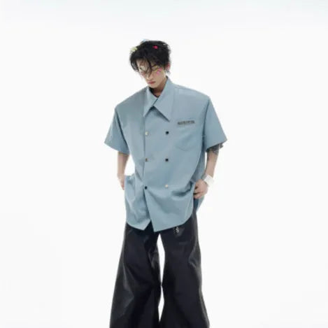 Men's loose-fitting short-sleeved casual summer shirt in black, showing splicing detail and lapel collar.
