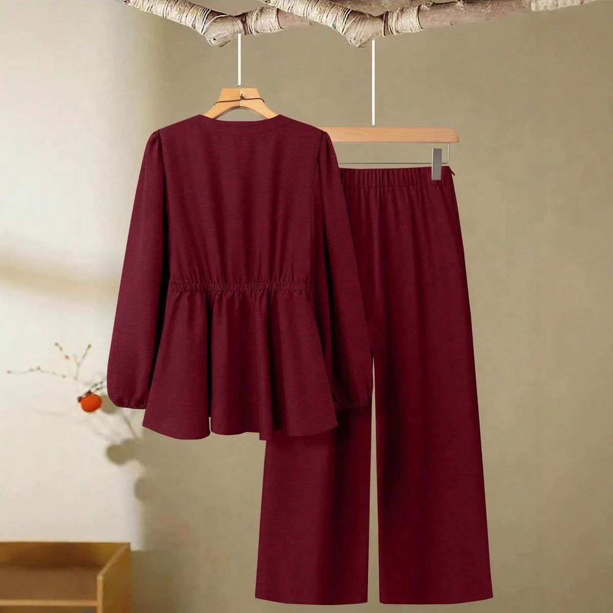 Women's long-sleeved two-piece polyester suit in khaki with button front top and matching trousers on model