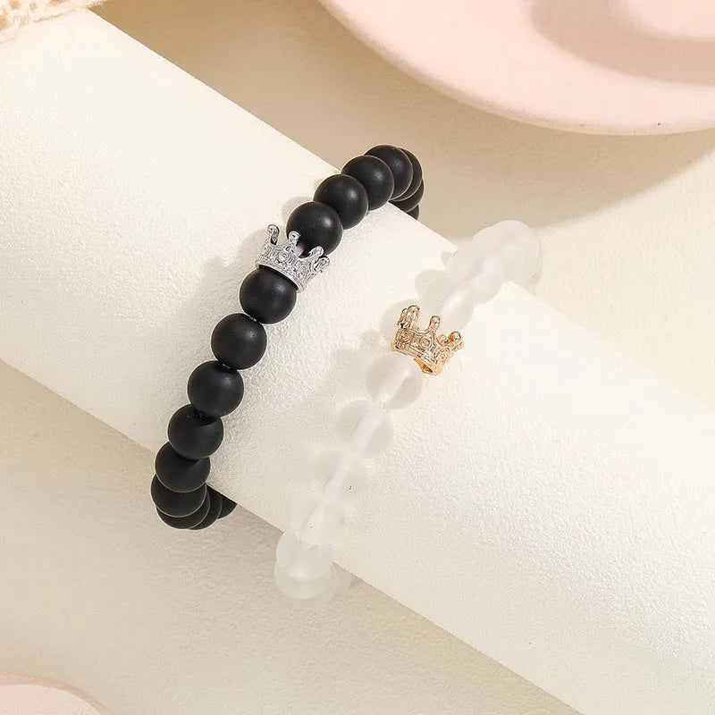 2pcs handmade glow-in-the-dark crown beaded bracelets in white and black with glass beads and luminous heart charm