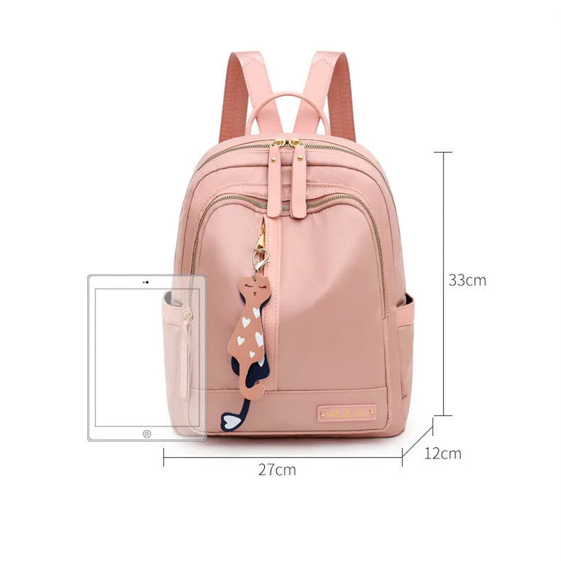 Black or pink women's casual nylon backpack with soft handle, showing internal zipper pockets and double shoulder straps.