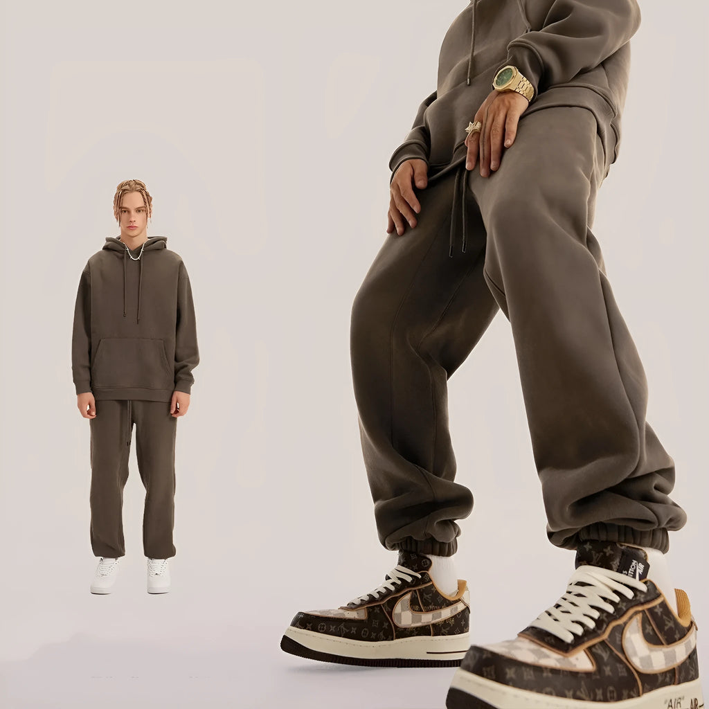 Man wearing dark brown cotton velvet sweatpants with an elasticated waist and ankle band.