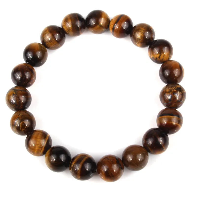 Natural tiger eye crystal bracelet with round beads in multiple colour options on a wrist.