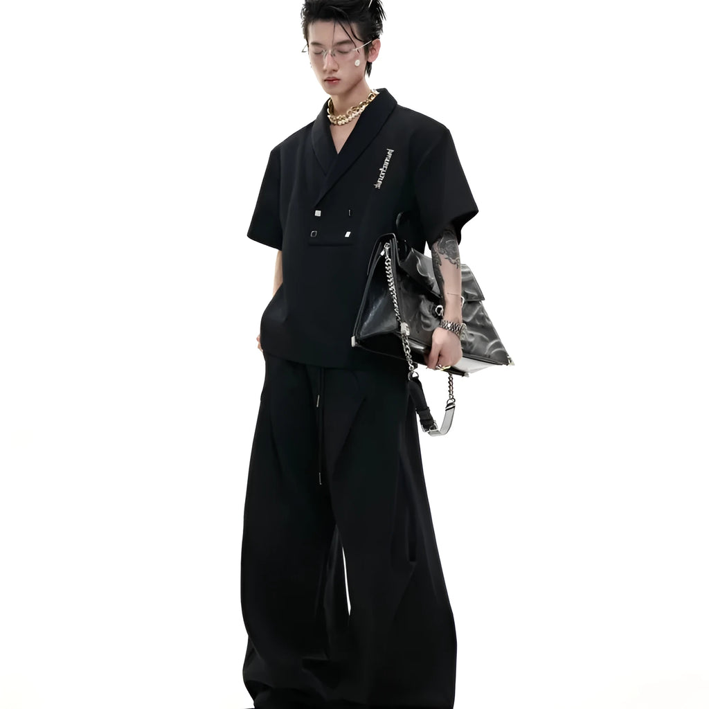 Men's dark grey V-neck sports jacket with padded shoulders and metal details paired with matching shorts