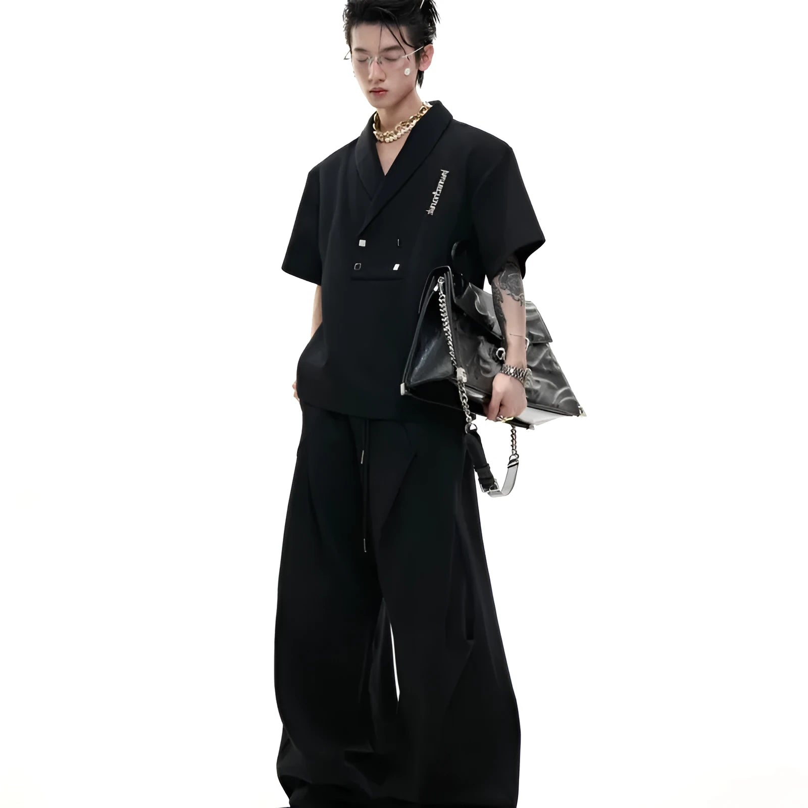 Men's dark grey V-neck sports jacket with padded shoulders and metal details paired with matching shorts