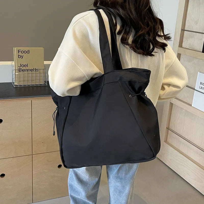 Oxford cloth shoulder tote bag in folding design showing soft construction and shoulder strap