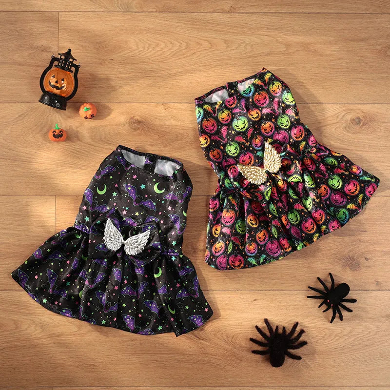 Dog wearing an angel wings Halloween costume in bright orange or purple colours