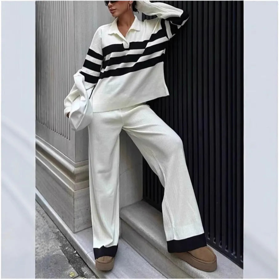 Women wearing black and white striped polo collar two-piece set with matching trousers