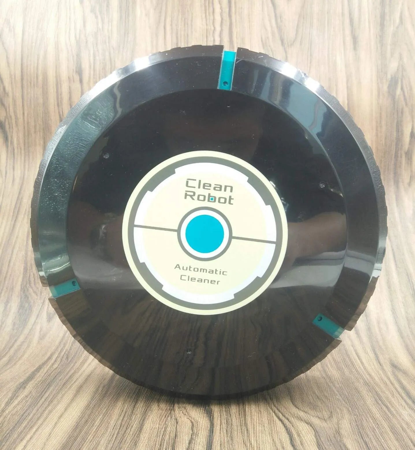AC automatic robot vacuum cleaner in black or white on a hardwood floor