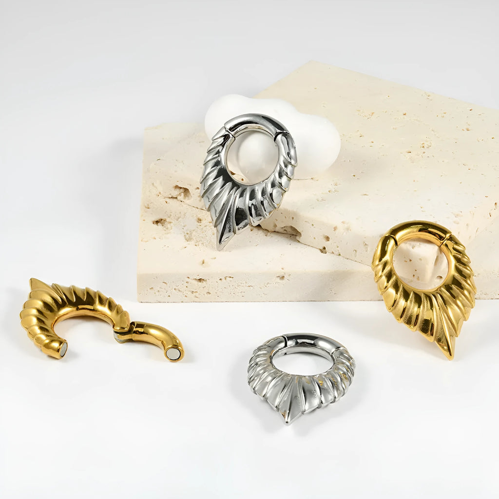 Stainless steel drop-shaped auricle ear extender with totem design for stretched earlobes.