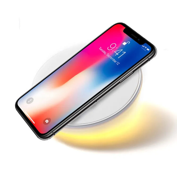 White wireless mobile phone charger with digital clock display showing the time