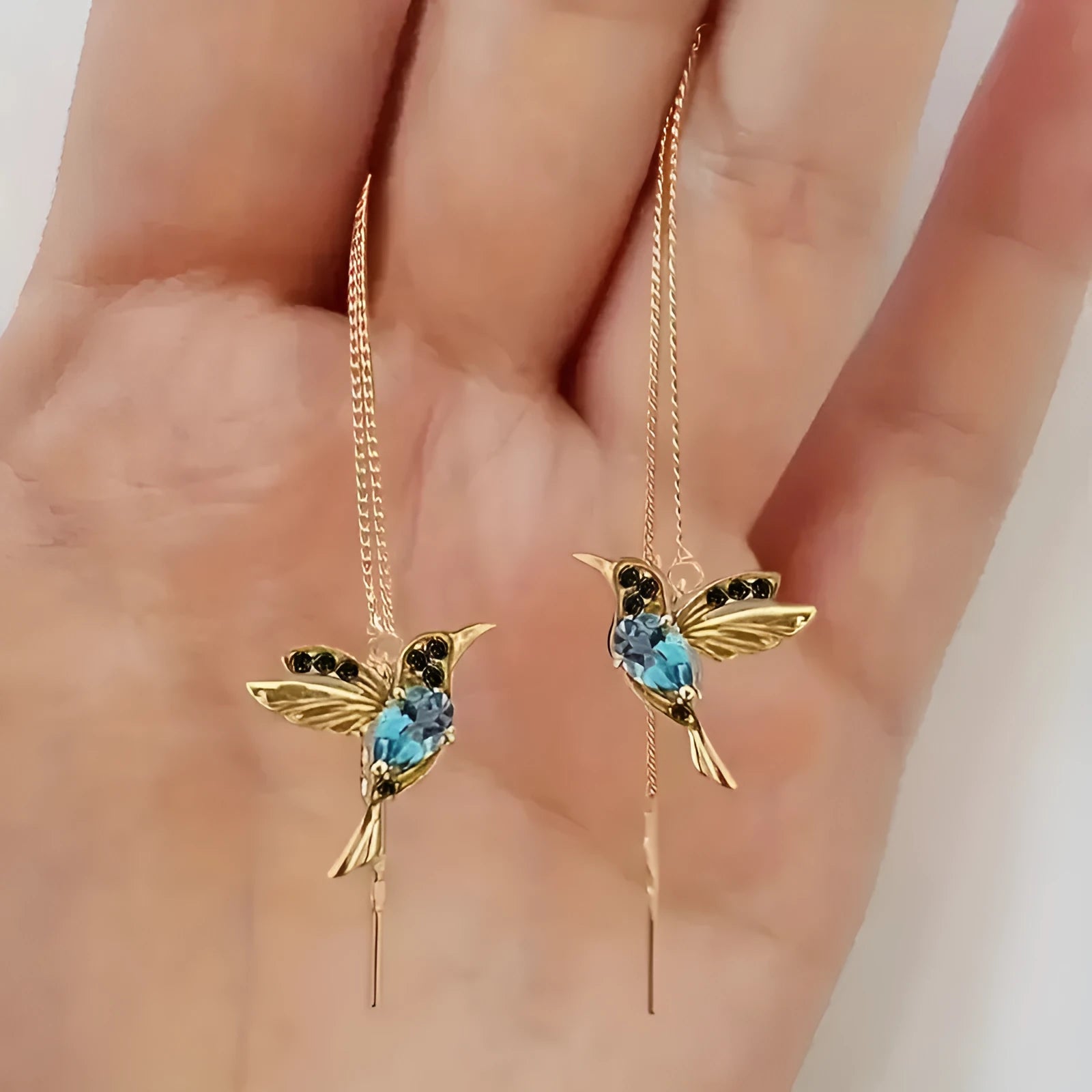Long style hanging earrings featuring a bird design with mixed zirconium wings in red and blue electroplated alloy