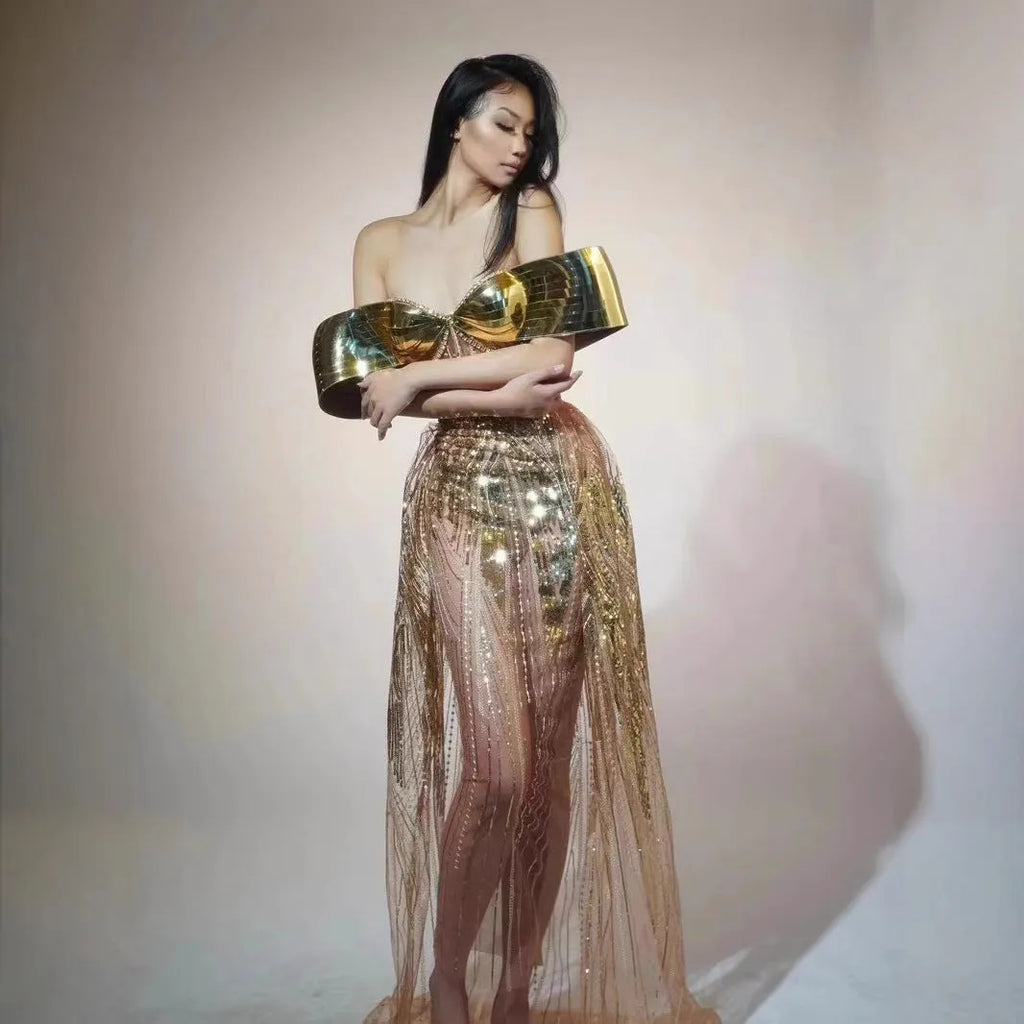 Gold sequined strapless evening dress with a thigh-high split in the long tulle skirt.