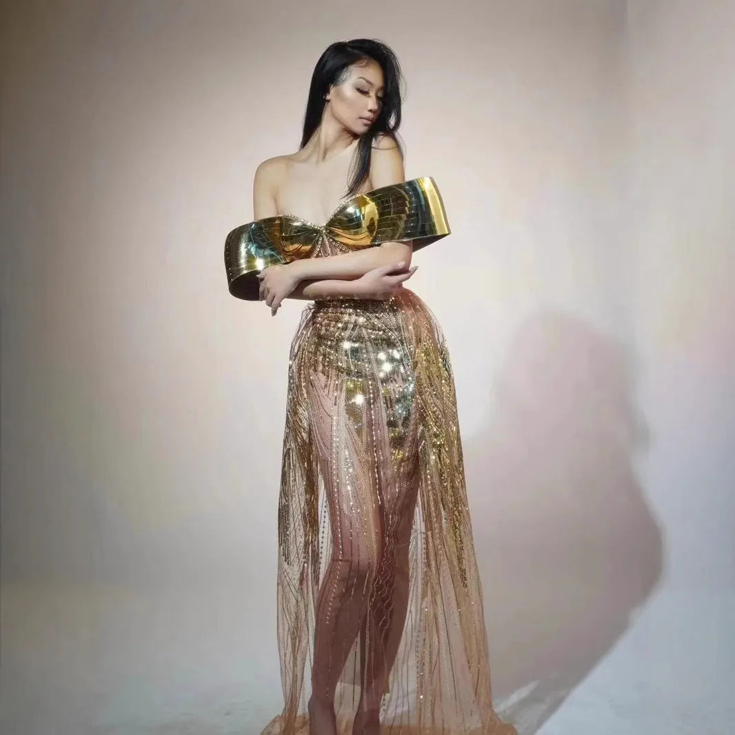 Gold sequined strapless evening dress with a thigh-high split in the long tulle skirt.