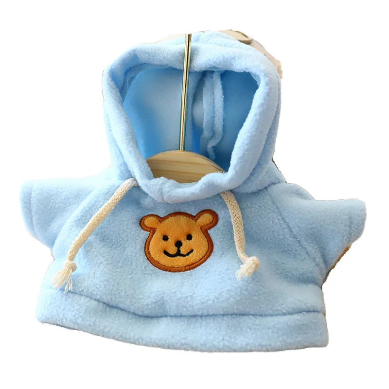 A blue cloth dog hoodie laid flat, showing its front and hood, with a net storage bag beside it.