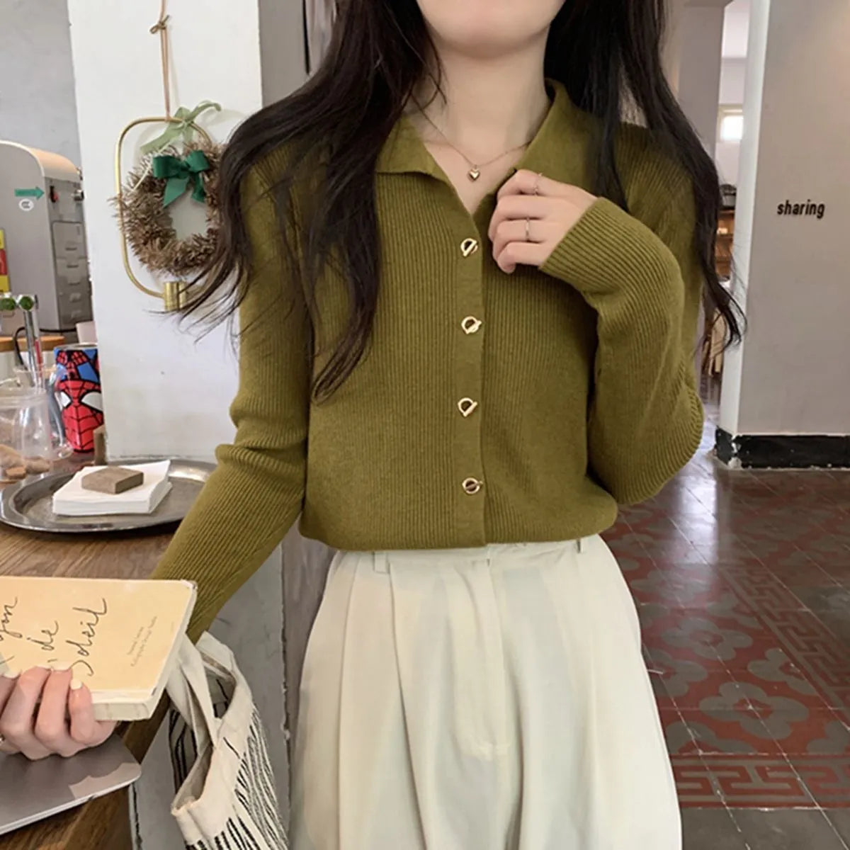 Beige loose fit long-sleeved viscose knitted cardigan for women shown as a layering piece.
