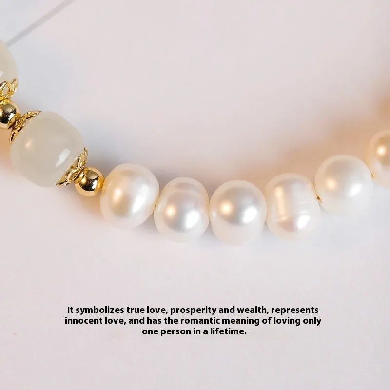 Close-up of a diamond-shaped freshwater pearl bracelet in an electroplated Hetian jade colour on a wrist.