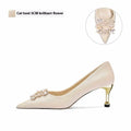 Pointed-toe crystal bridal high heels with rhinestones on a cloth upper, showing stiletto and cat heel options.