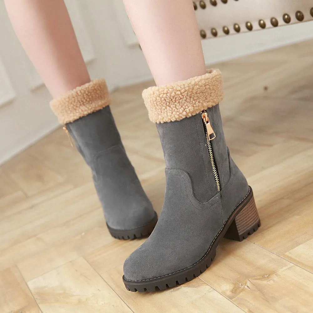 Men's black waterproof snow boots with thick rubber sole and plush lining on a snowy background.