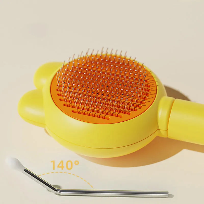 Self-cleaning pet grooming brush with coloured handle and stainless steel comb teeth