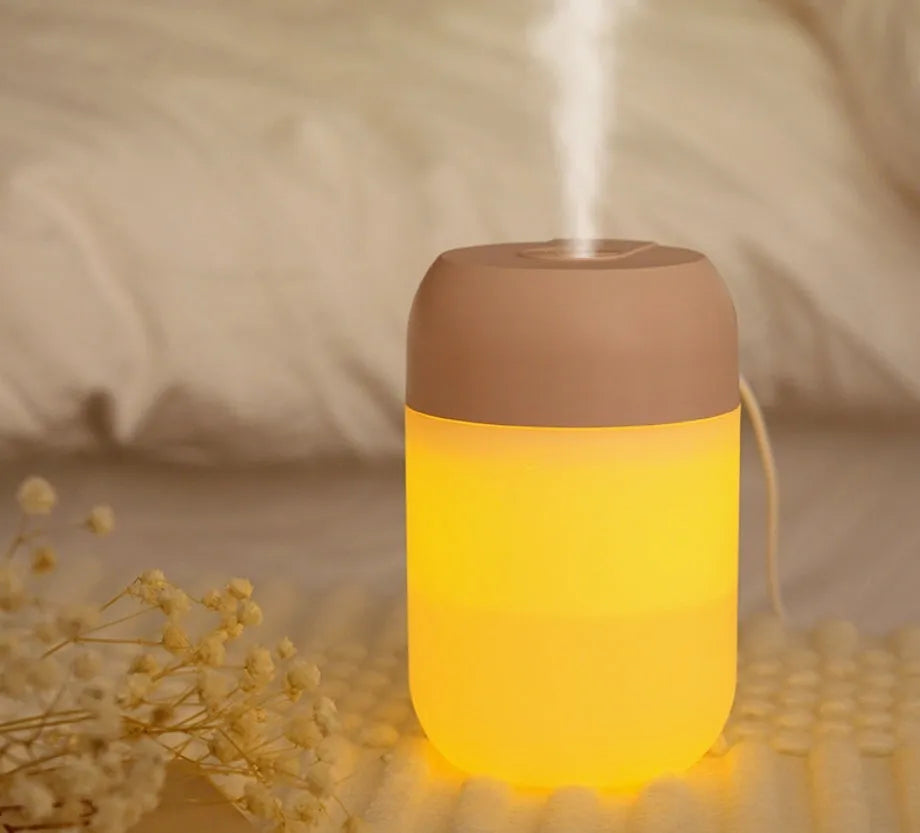 White cylindrical mini humidifier with USB cable for portable operation in small rooms