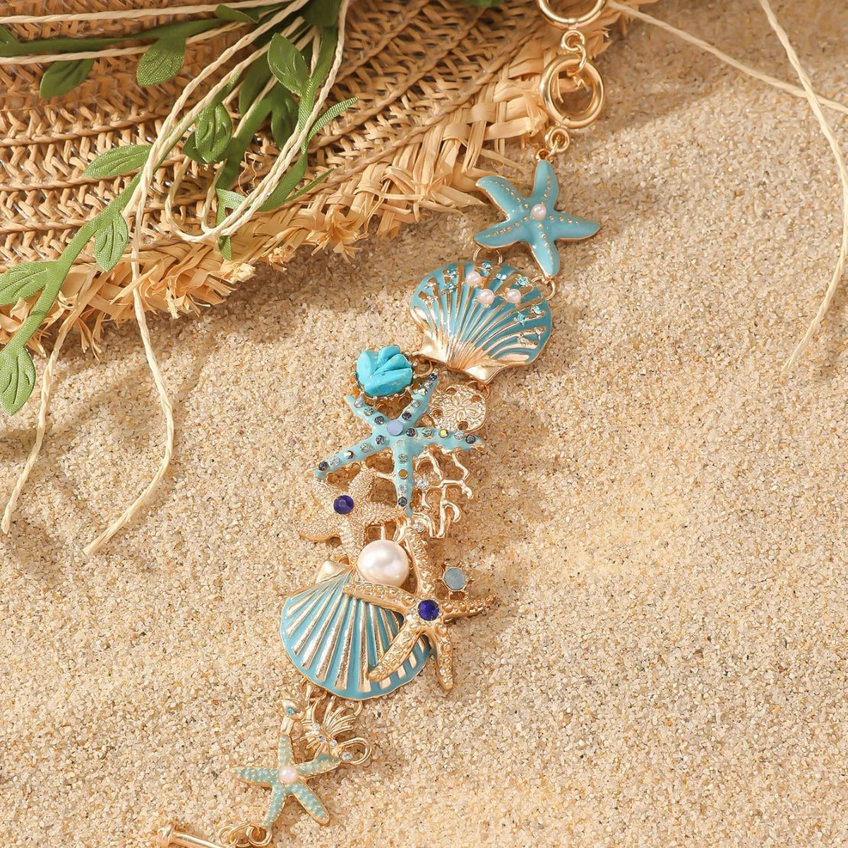 Women's alloy bracelet with starfish and boat anchor rhinestones in turquoise, red, or blue.