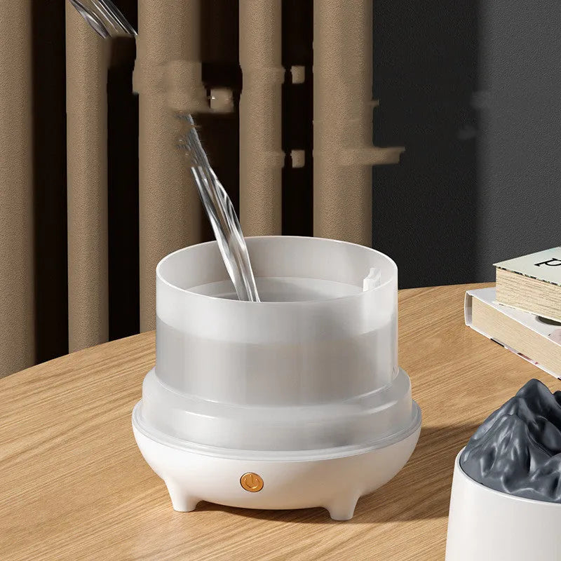 Black volcanic sculpture USB humidifier and aromatherapy diffuser on a wooden surface.
