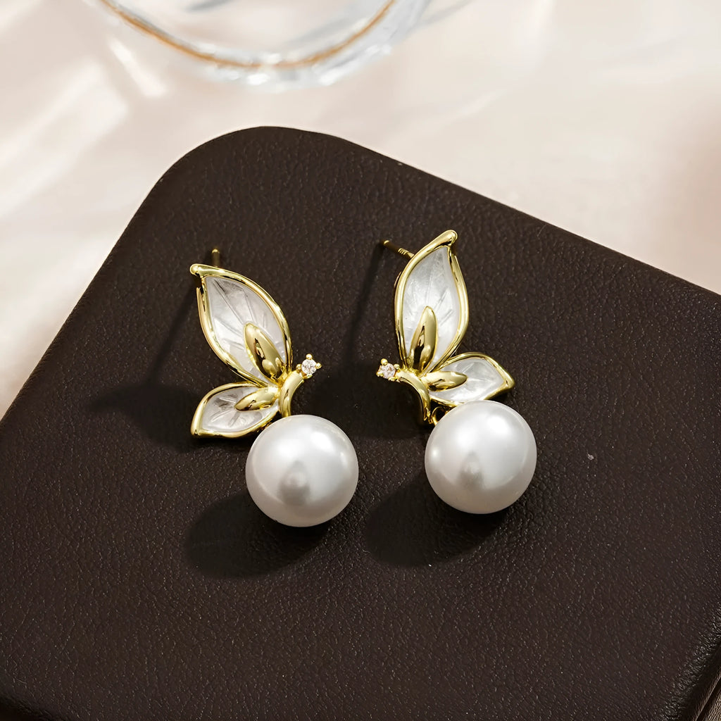 A pair of simple butterfly drop earrings for women with an electroplated finish on a copper base.