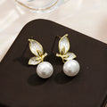 A pair of simple butterfly drop earrings for women with an electroplated finish on a copper base.