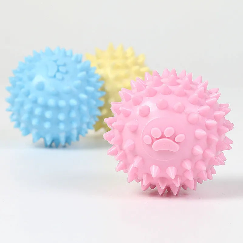 Blue TPR dog chewing ball with footprint design and bulging sides for tooth cleaning.