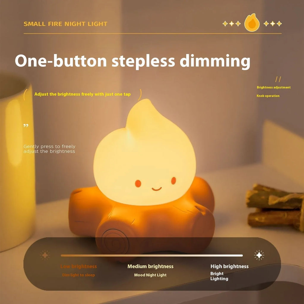 Cartoon silicone small fire pile night lamp with yellow light on a surface.