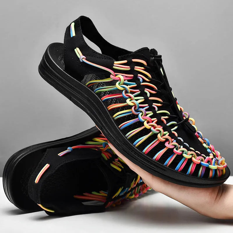 Casual woven sandals with drawstring tie closure in a rainbow colour pattern on a rubber sole.
