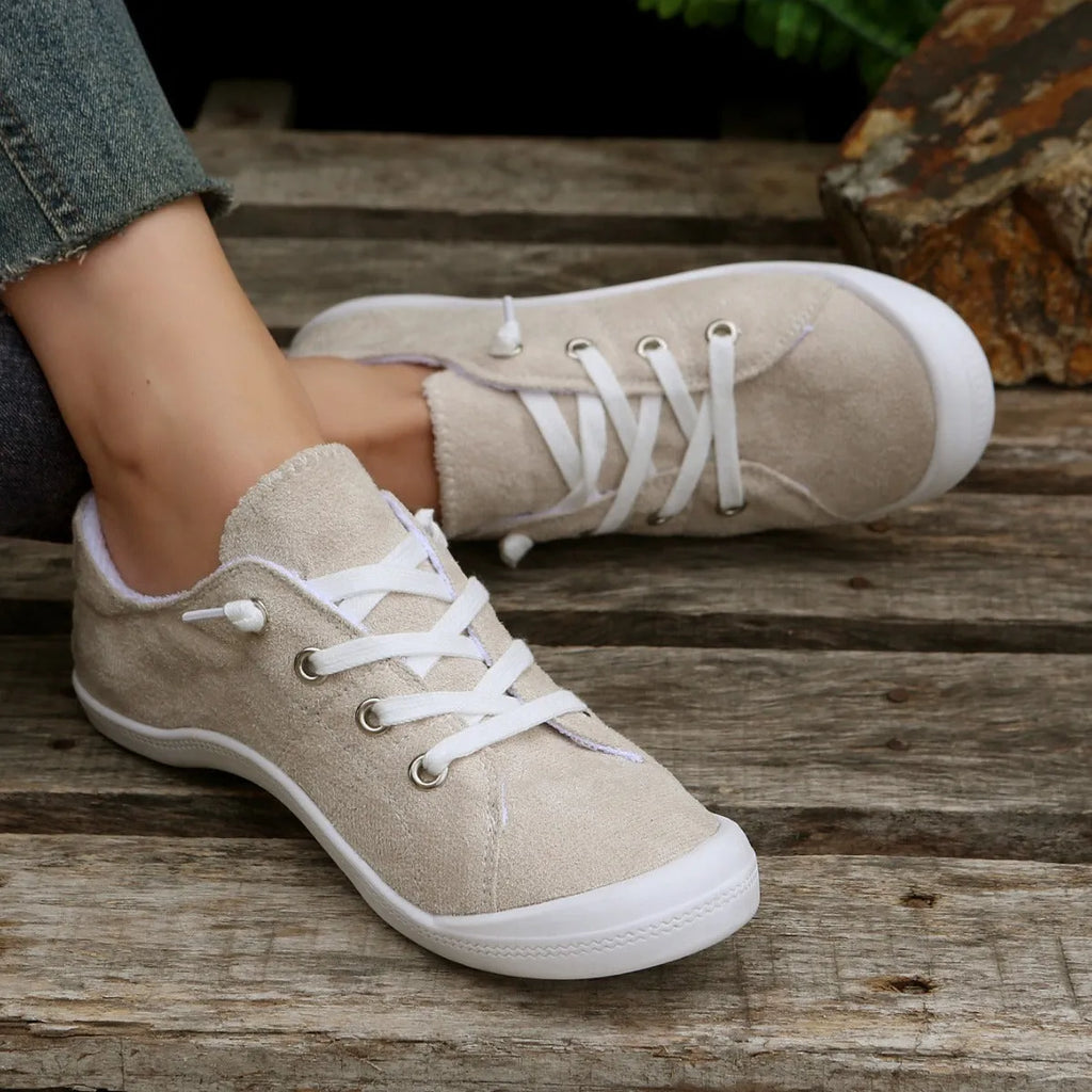 Women's creamy white low-top casual sneakers with fabric upper and rubber outsole on a neutral background