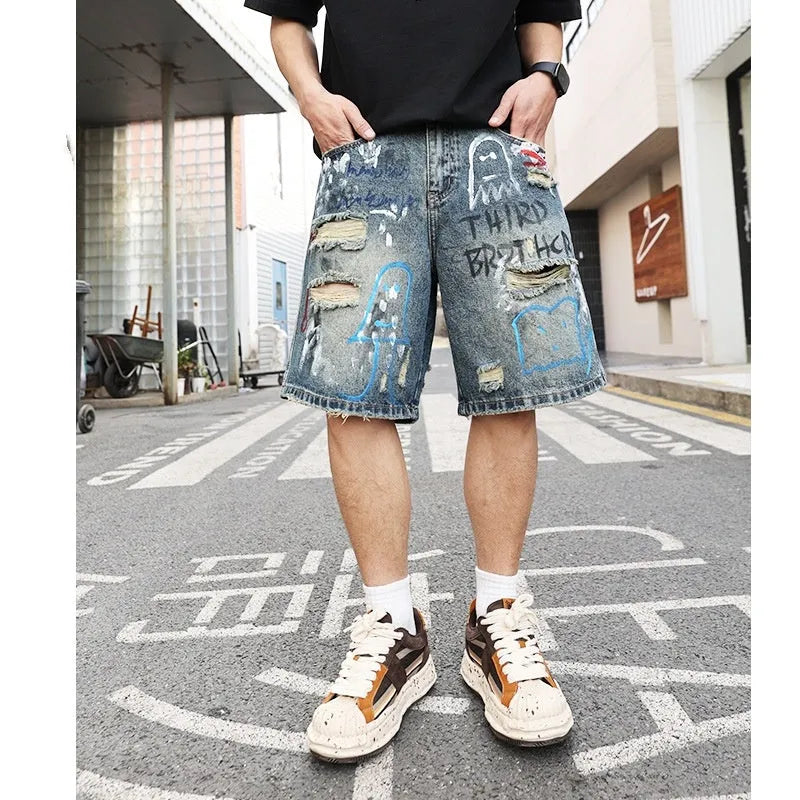 Men's blue ripped jeans shorts with graffiti details and straight leg opening
