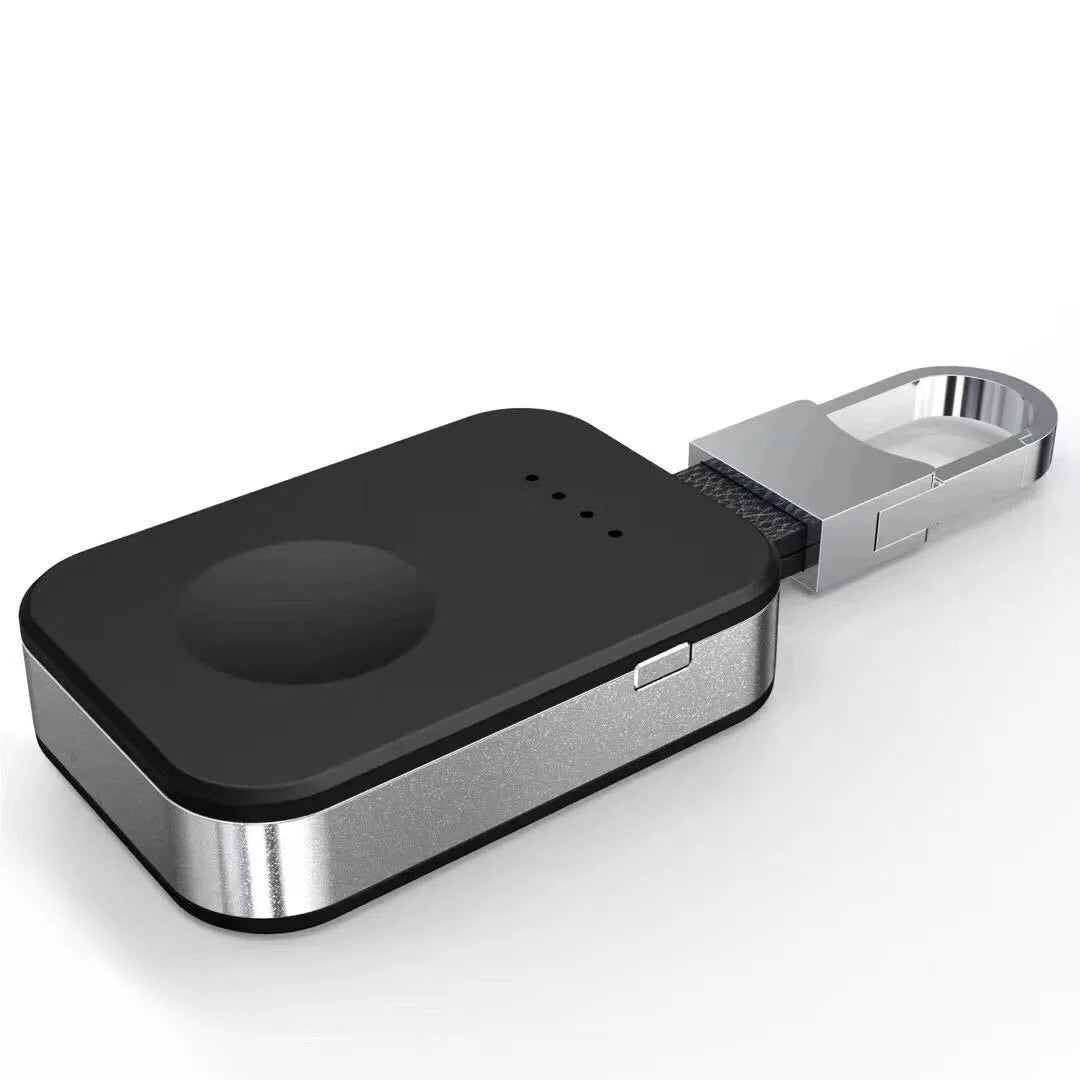 Black Apple Watch wireless charging power bank on a keyring, showing compact size.