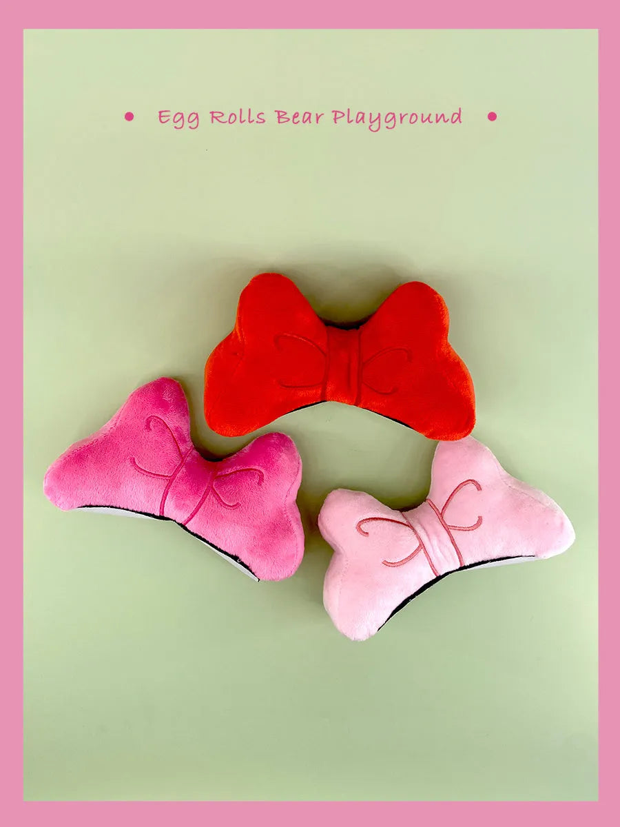 Plush bow helmet decoration in red, pink, and rose pink colours for motorcycle and ski helmets